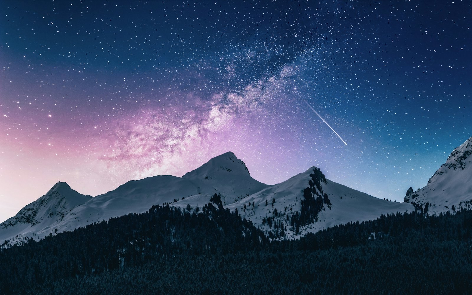 A lone mountain peak beneath a vast field of stars
