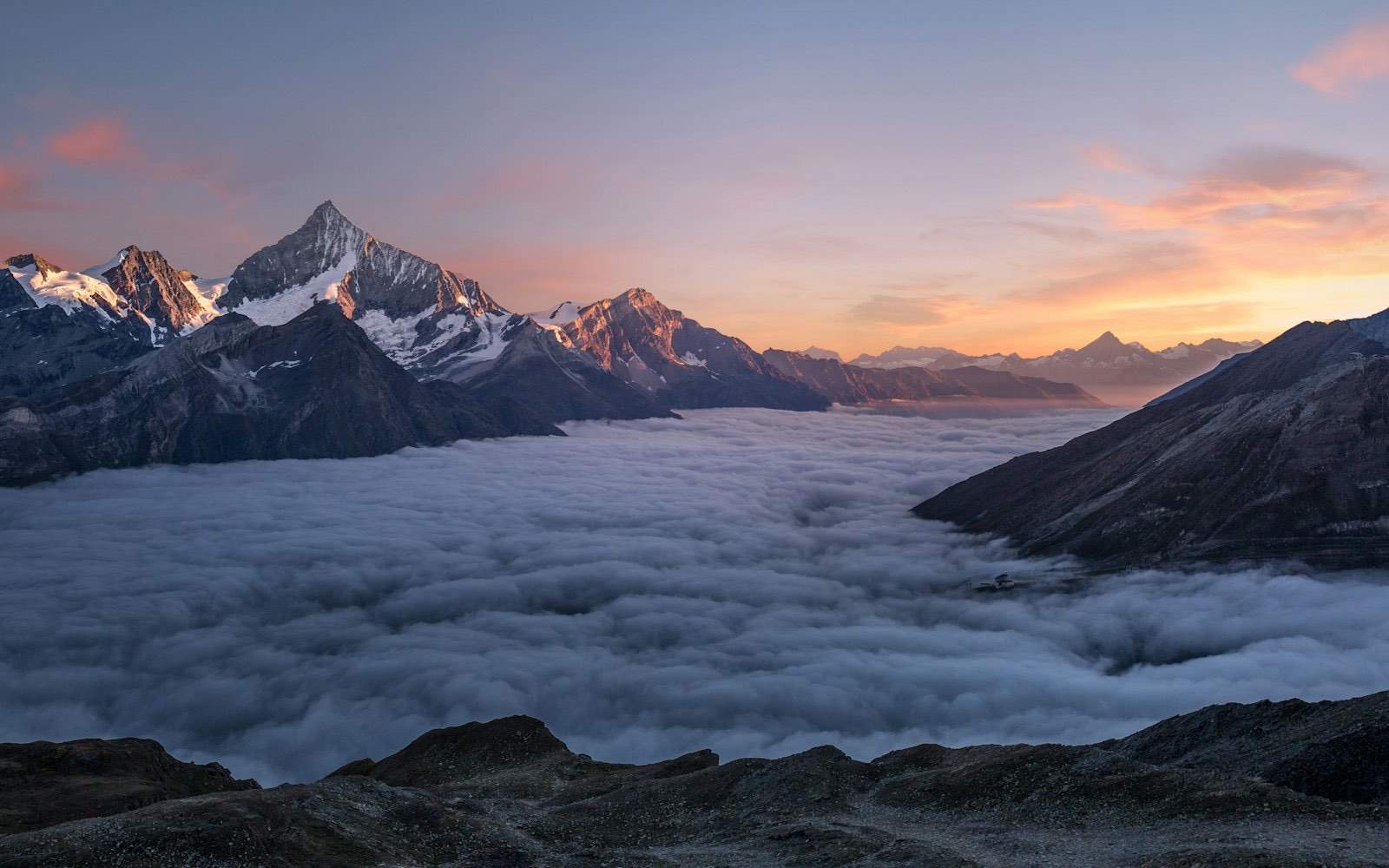 Warm sunset light over a still mountain lake