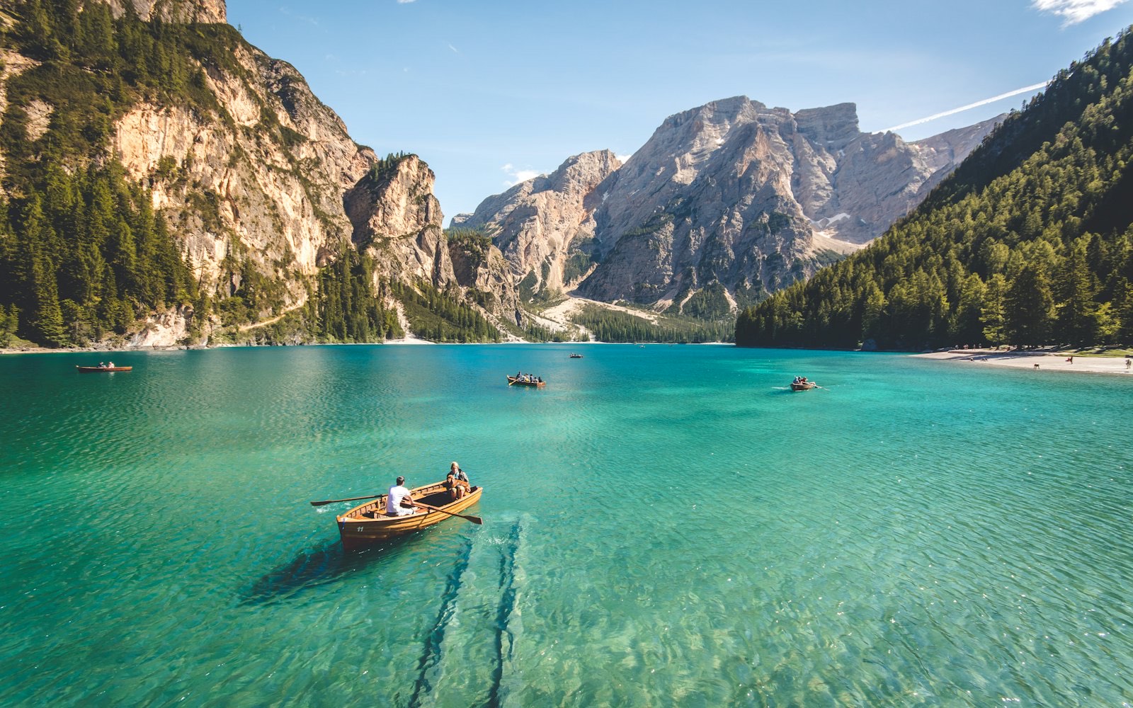 A calm mountain lake stretching toward distant peaks